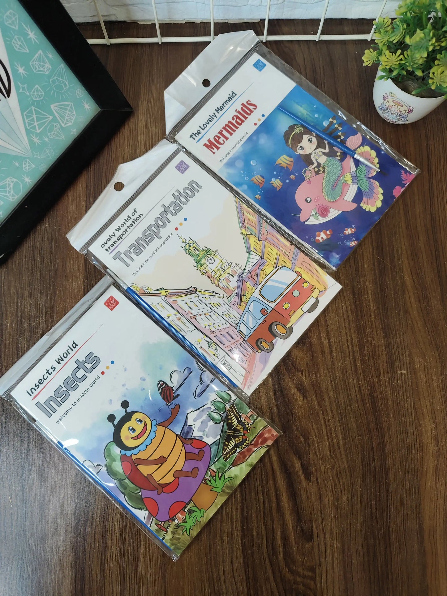 Kids painting books, with watercolors and brush